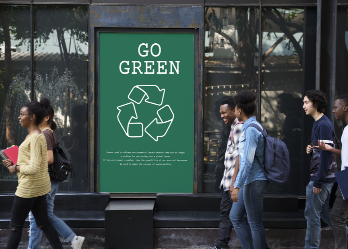 College students walking by 'Go Green' advertisement.