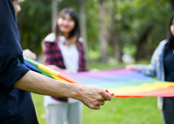 College students holding pride flag