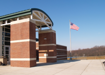 American flag displaying in fron of college building